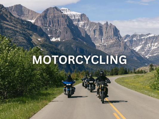 Group of motorcyclists riding on a scenic mountain road.