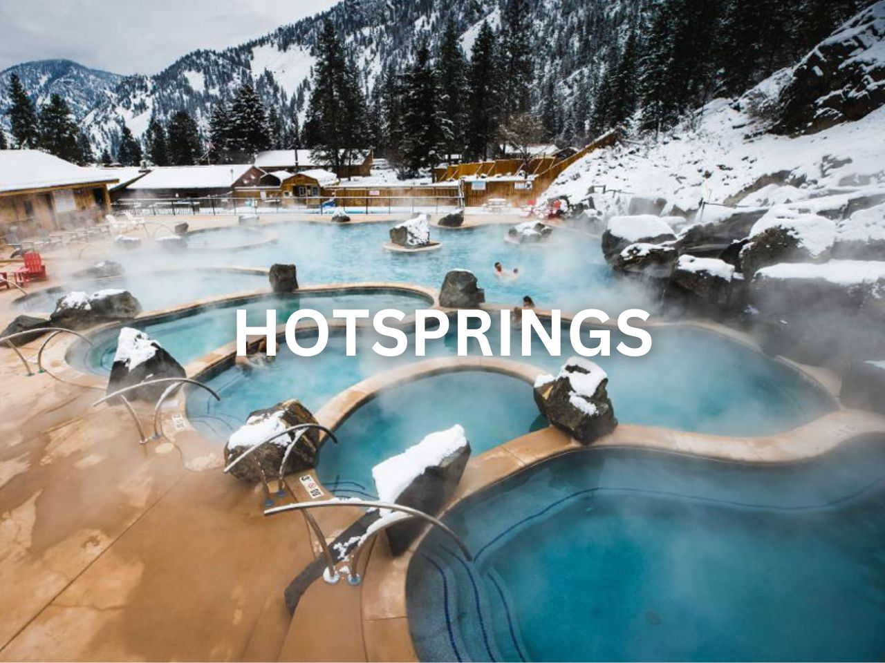 A serene winter landscape featuring steaming hot springs surrounded by snow-covered trees and a clear blue sky.