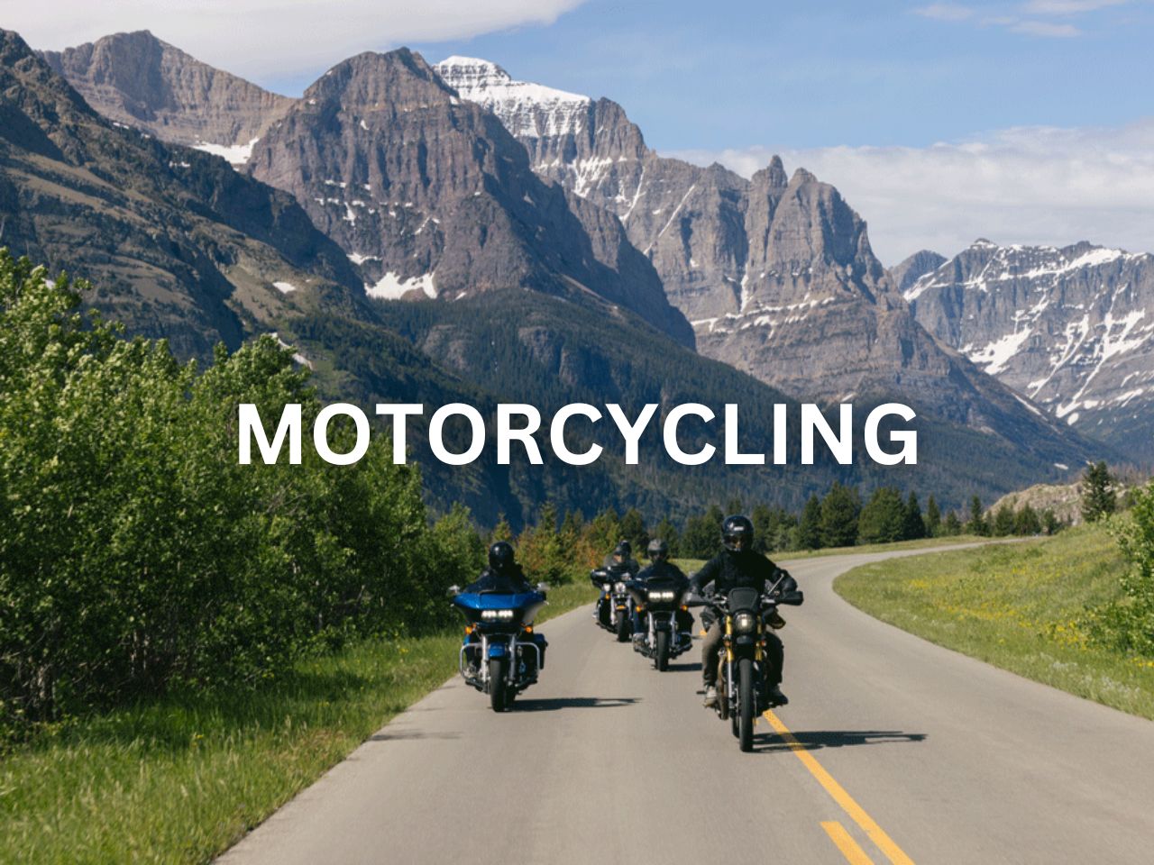 Motorcyclists riding along a scenic mountain road.