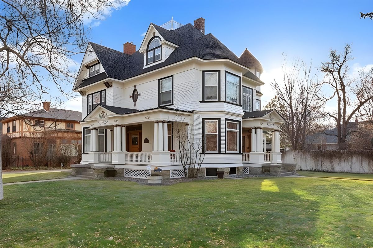 Large white house featuring expansive front porch