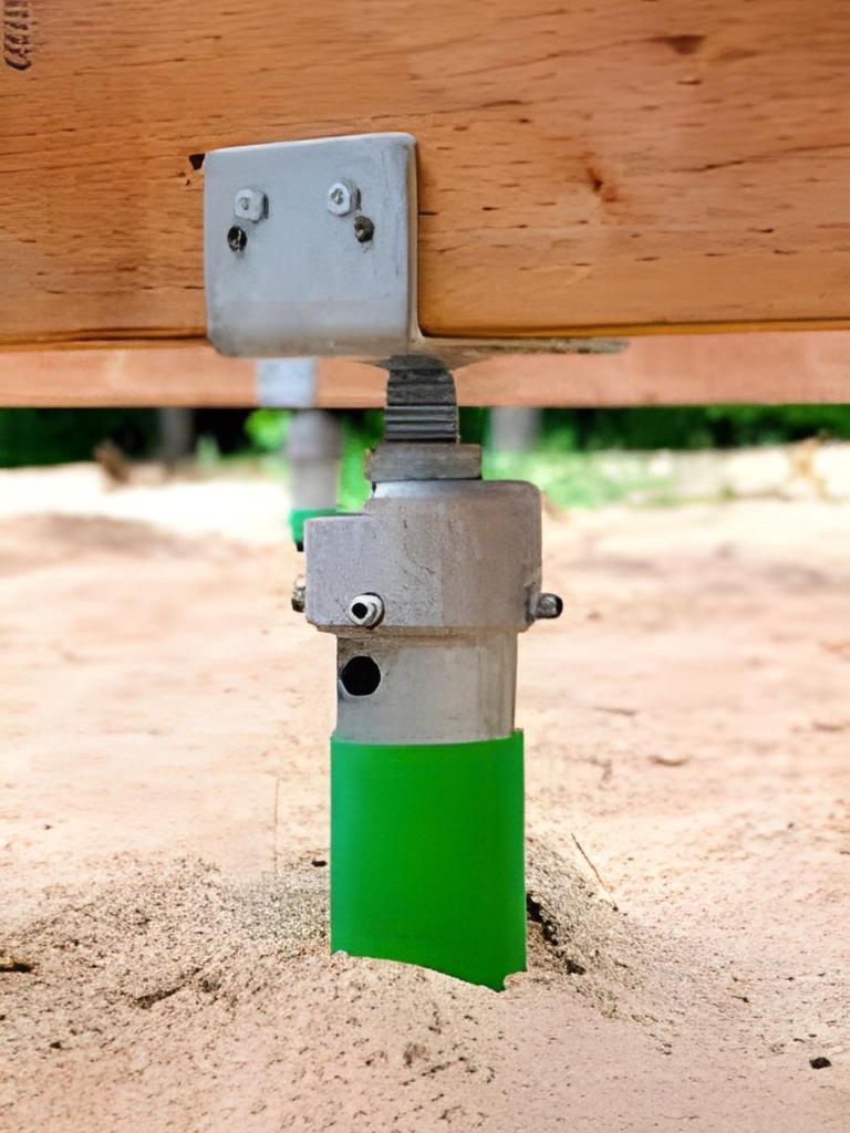 A green valve on a wooden structure, providing control and regulation in an industrial setting.